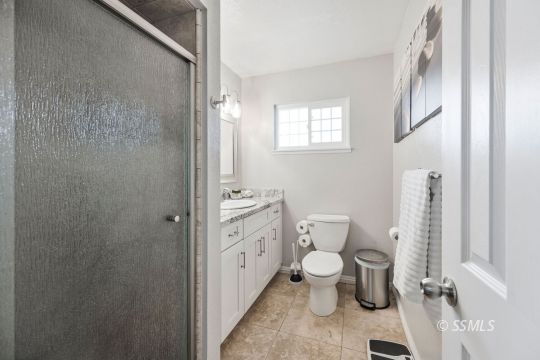 1341 Sims Street Ridgecrest, CA 93555 - Photo 21 of 27 a bathroom with a toilet sink and a shower