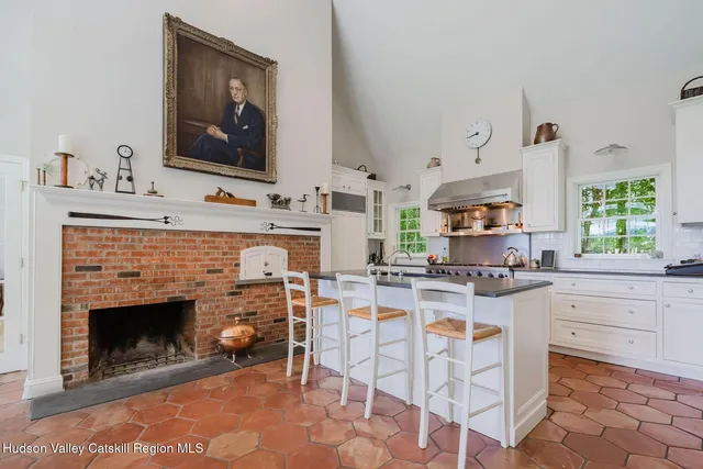 a living room with furniture fireplace and a large window