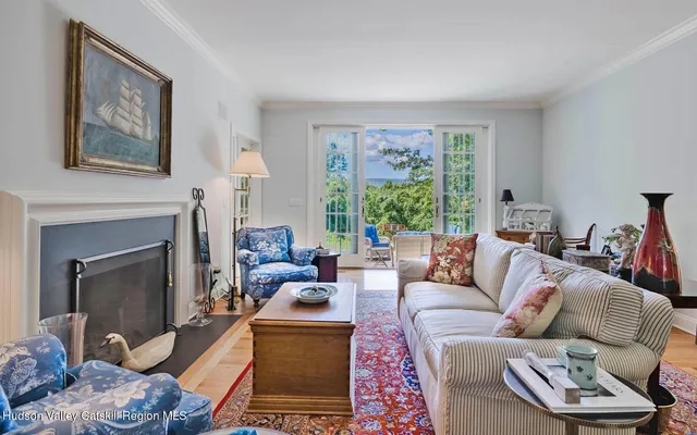 a living room with furniture fireplace and a large window