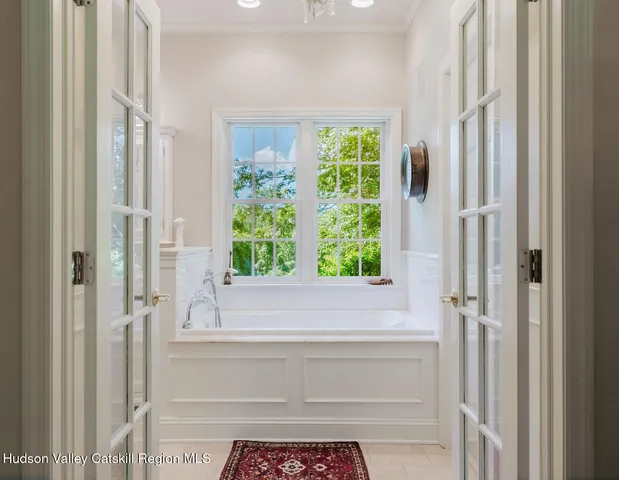 a bedroom with a bed and a wooden floor
