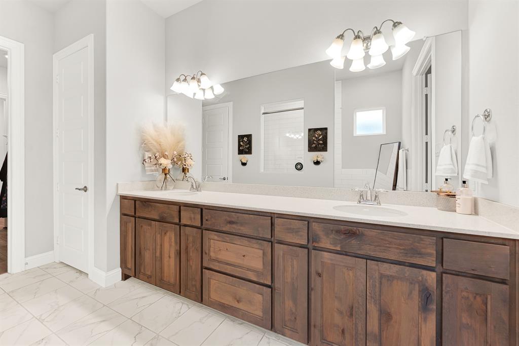 6404 Trezevant Street Rowlett, TX 75089 - Photo 19 of 30 a bathroom with a double vanity sink and a mirror