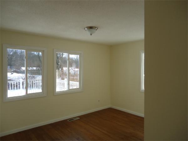 81 Crestmont Street Springfield, MA 01108 - Photo 13 of 15 an empty room with wooden floor and windows