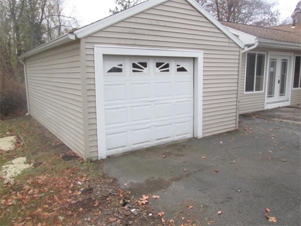 81 Crestmont Street Springfield, MA 01108 - Photo 5 of 15 a view of a white house with a yard and garage