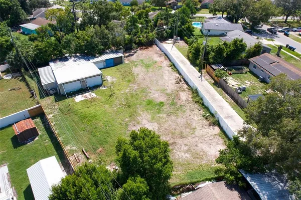 an aerial view of a house with a yard and lake view