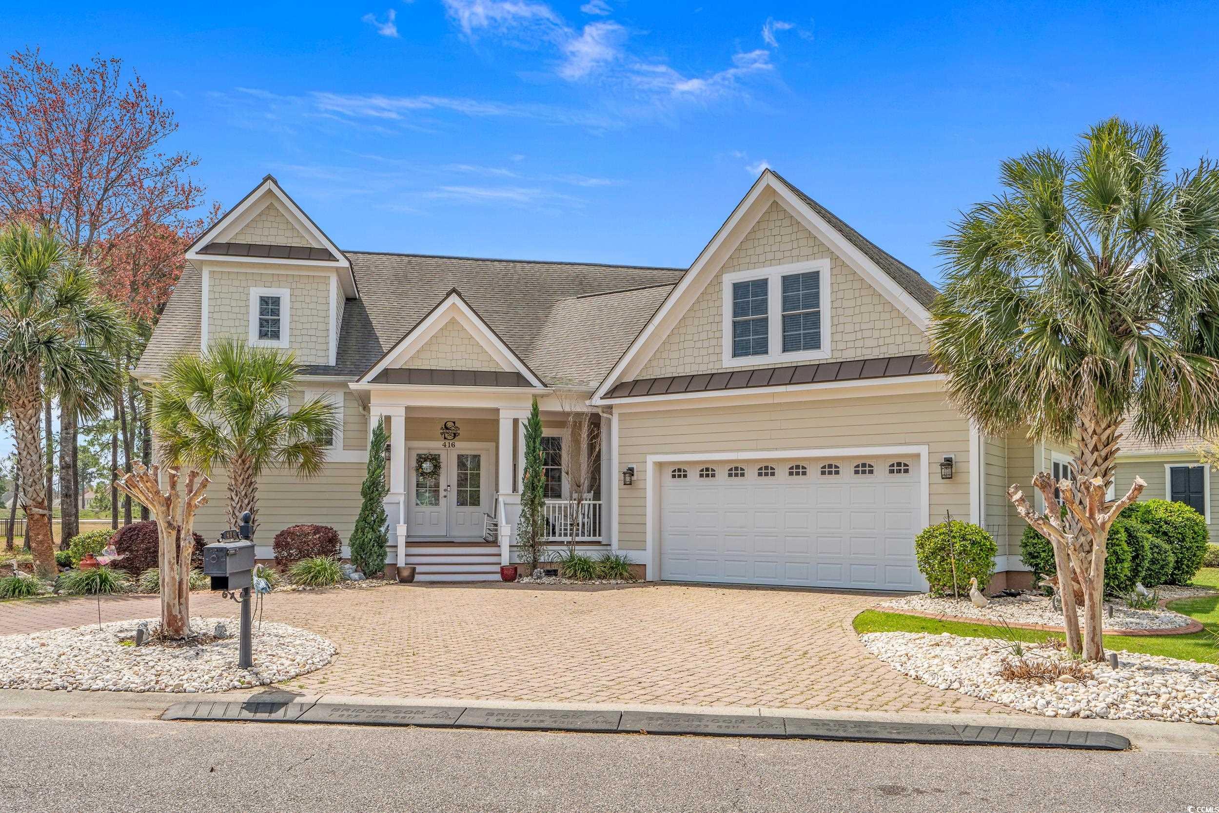 416 Seabury Lane Myrtle Beach, SC 29579 - Photo 1 of 39 View of front of house featuring decorative driveway, a garage, a standing seam roof, covered porch, and french doors