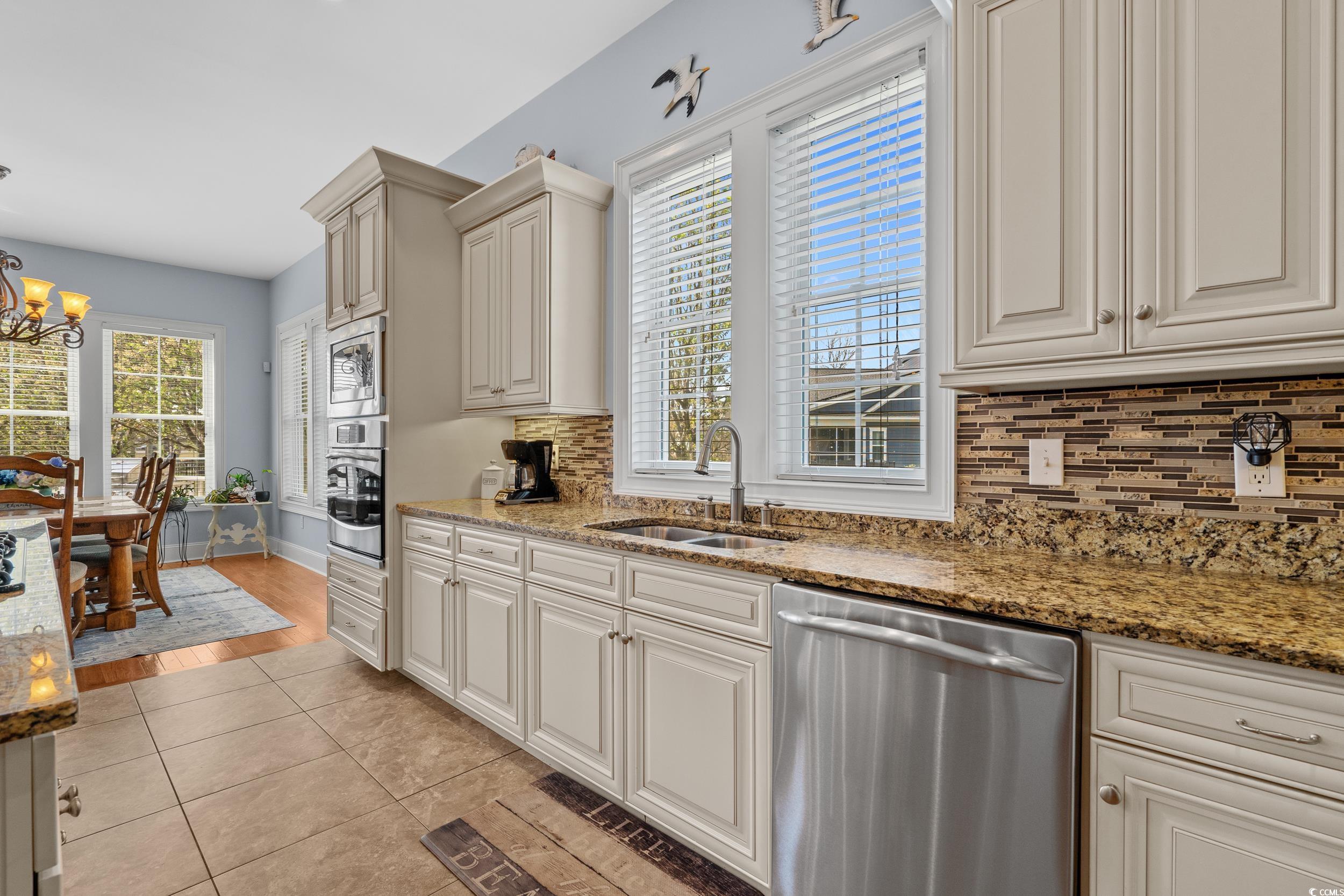 416 Seabury Lane Myrtle Beach, SC 29579 - Photo 38 of 39 Kitchen featuring open floor plan, gas cooktop, light tile patterned floors, and an inviting chandelier
