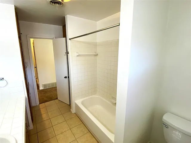 a bathroom with a shower and a toilet