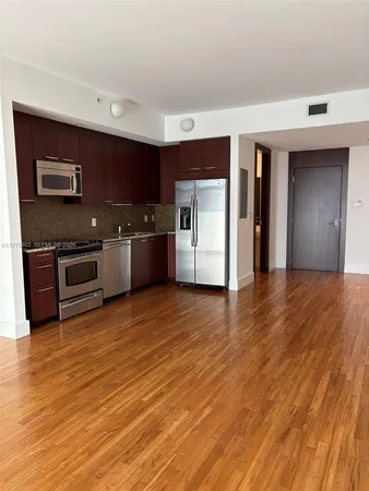 a view of a kitchen with a sink and a stove top oven