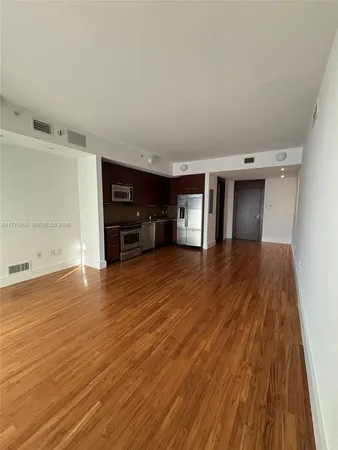 a view of a livingroom with furniture and a flat screen tv