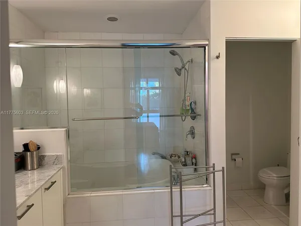 a bathroom with a shower and a sink