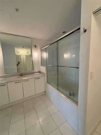 a bathroom with a mirror and a shower