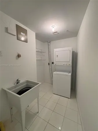 a utility room with cabinets washer and dryer