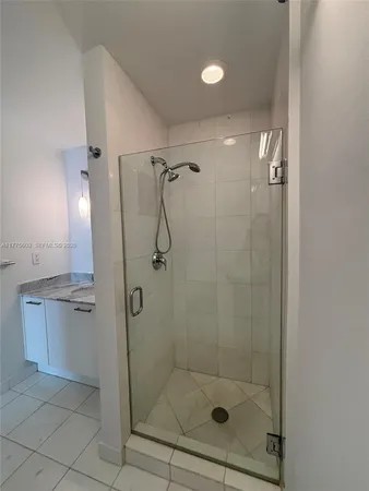 a bathroom with a granite countertop toilet and a sink