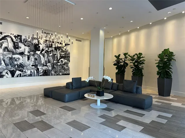 a living room with furniture and potted plant