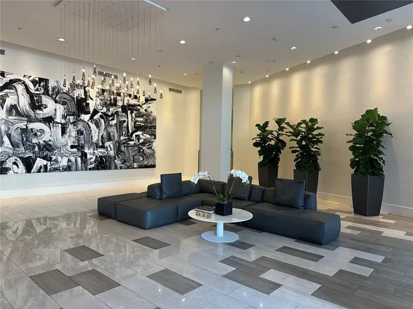 a living room with furniture and potted plant