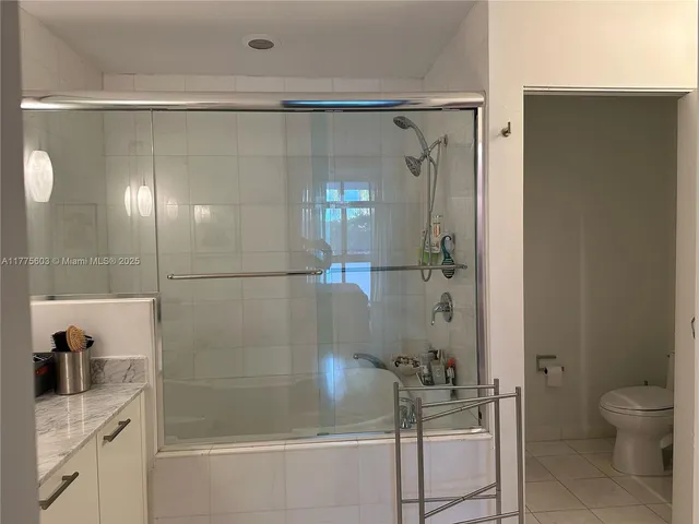 a bathroom with a shower and a sink