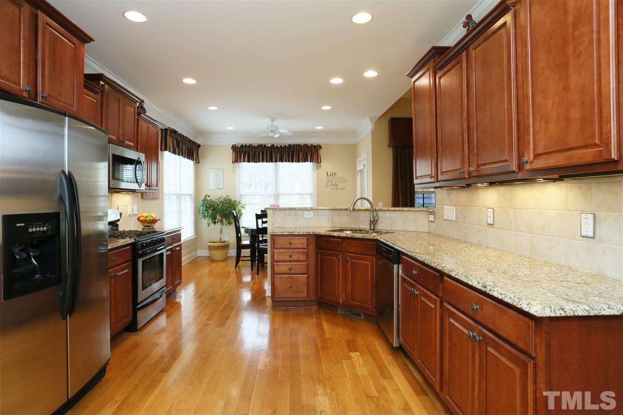488 May Farm Road Pittsboro, NC 27312 - Photo 9 of 30 Granite countertops and stainless steel appliances in spacious kitchen