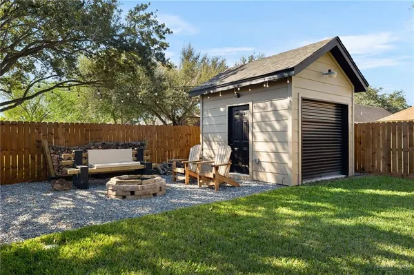 a view of a house with backyard and sitting area