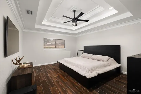 a bedroom with a bed and a chandelier