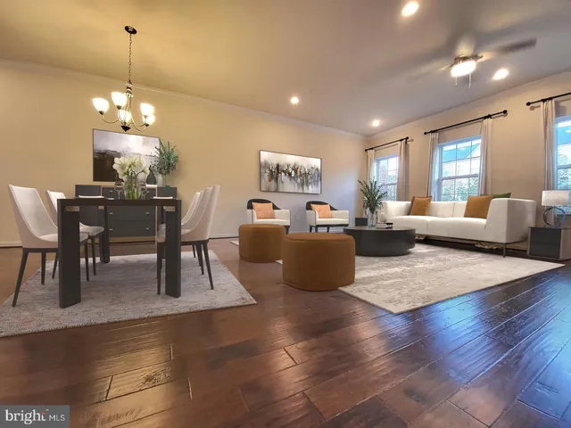 a living room with furniture wooden floor and dining table