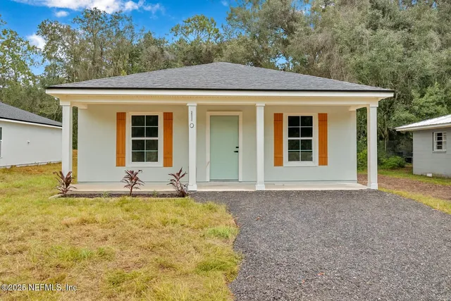 a front view of a house with a yard garage and outdoor seating