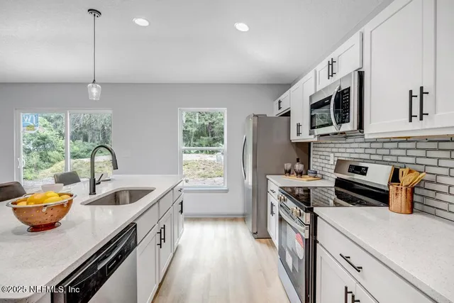 a kitchen that has a sink and a stove