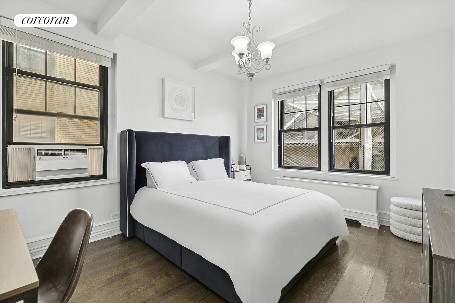 172 West 79th Street, Unit 8E Manhattan, NY 10024 - Photo 4 of 7 a large bed sitting in a bedroom next to a window