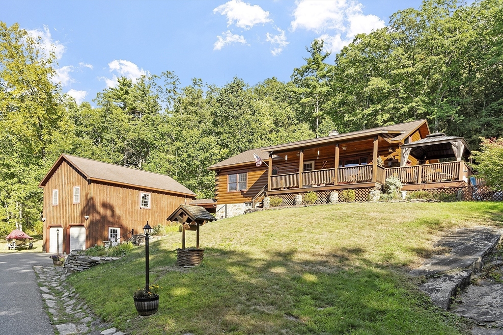 a backyard of a house with table and chairs