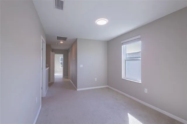 an empty room with windows and closet