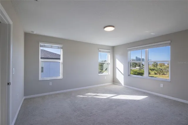 an empty room with windows and closet