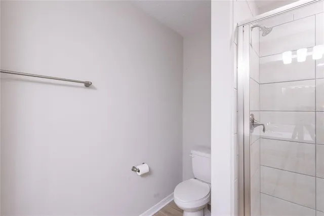 a bathroom with a shower and a toilet