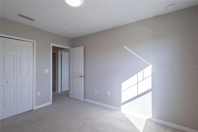 a view of an empty room and a window