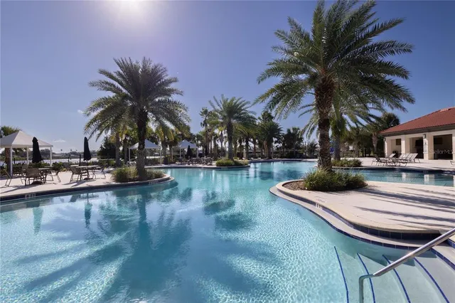 a view of a swimming pool with outdoor seating