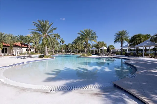 a swimming pool with outdoor seating and garden