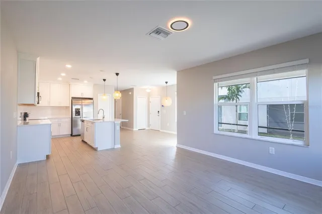 a view of kitchen with furniture and wooden floor