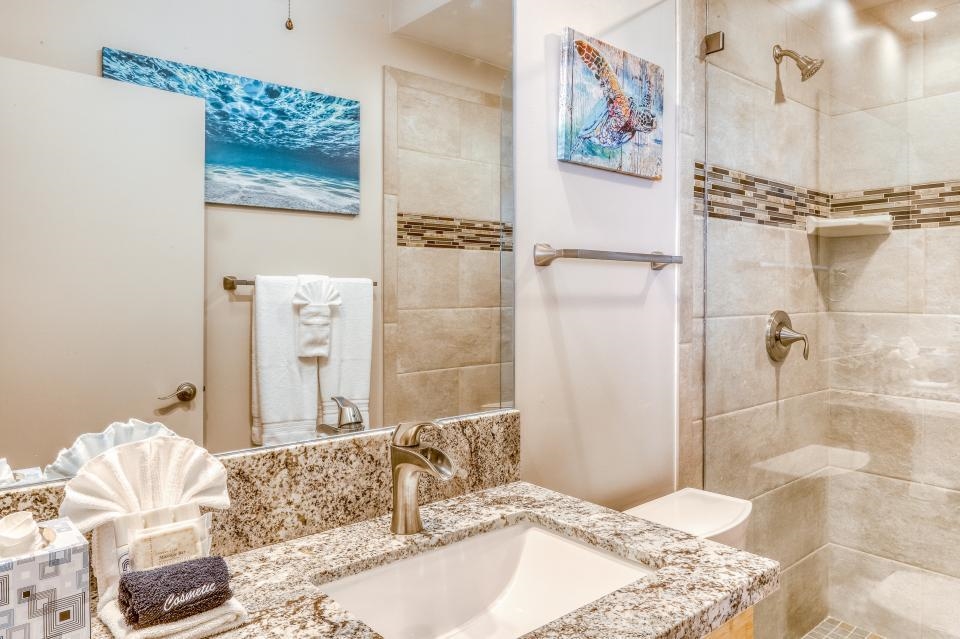4435 Lower Honoapiilani Road, Unit 204 Lahaina, HI 96761 - Photo 15 of 26 a bathroom with a granite countertop sink a mirror and shower