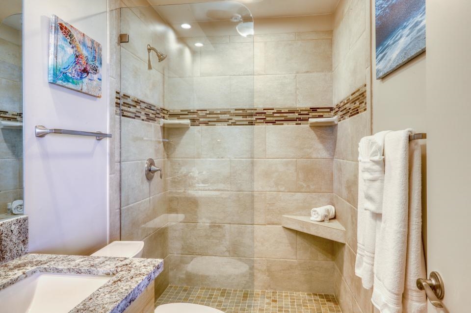 4435 Lower Honoapiilani Road, Unit 204 Lahaina, HI 96761 - Photo 3 of 26 a bathroom with a granite countertop shower and a sink