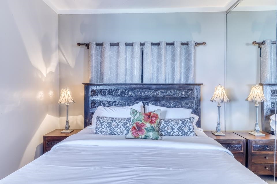 4435 Lower Honoapiilani Road, Unit 204 Lahaina, HI 96761 - Photo 8 of 26 a spacious bedroom with a bed and a fireplace