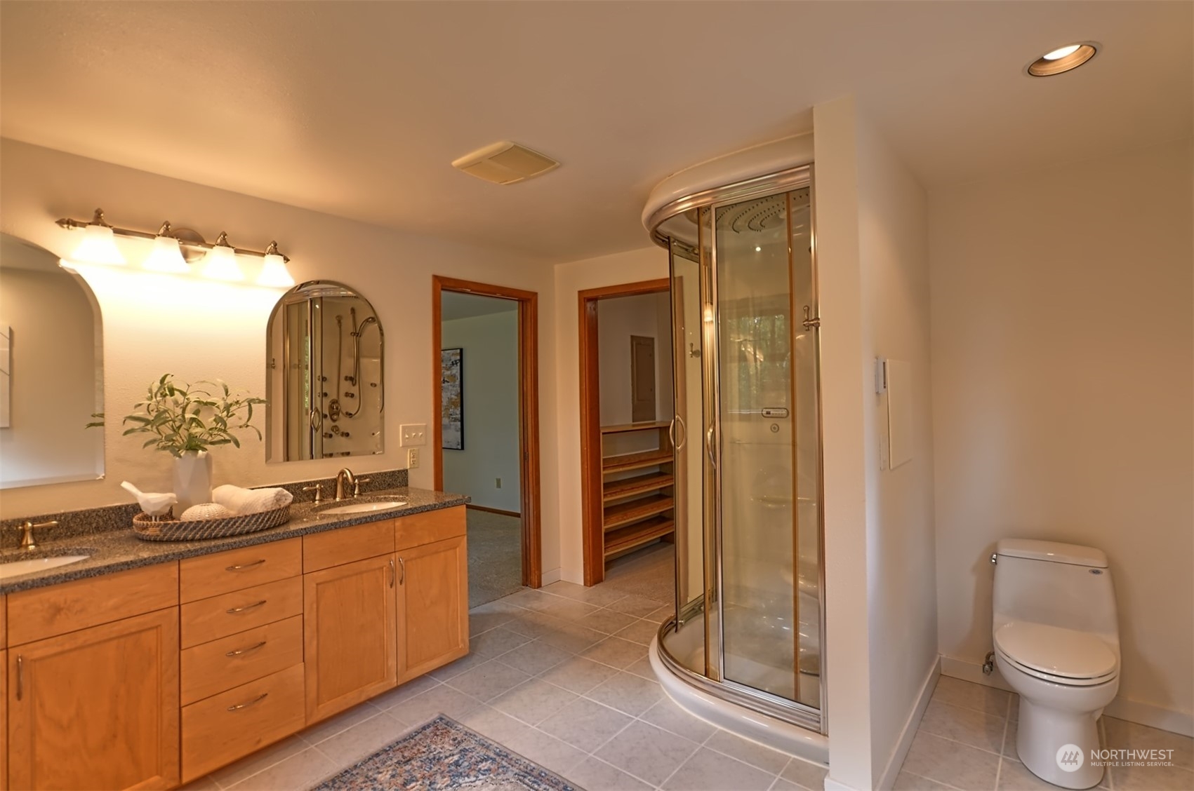 1004 218th Place Southeast Bothell, WA 98021 - Photo 14 of 30 a spacious bathroom with a double vanity sink a toilet and a shower