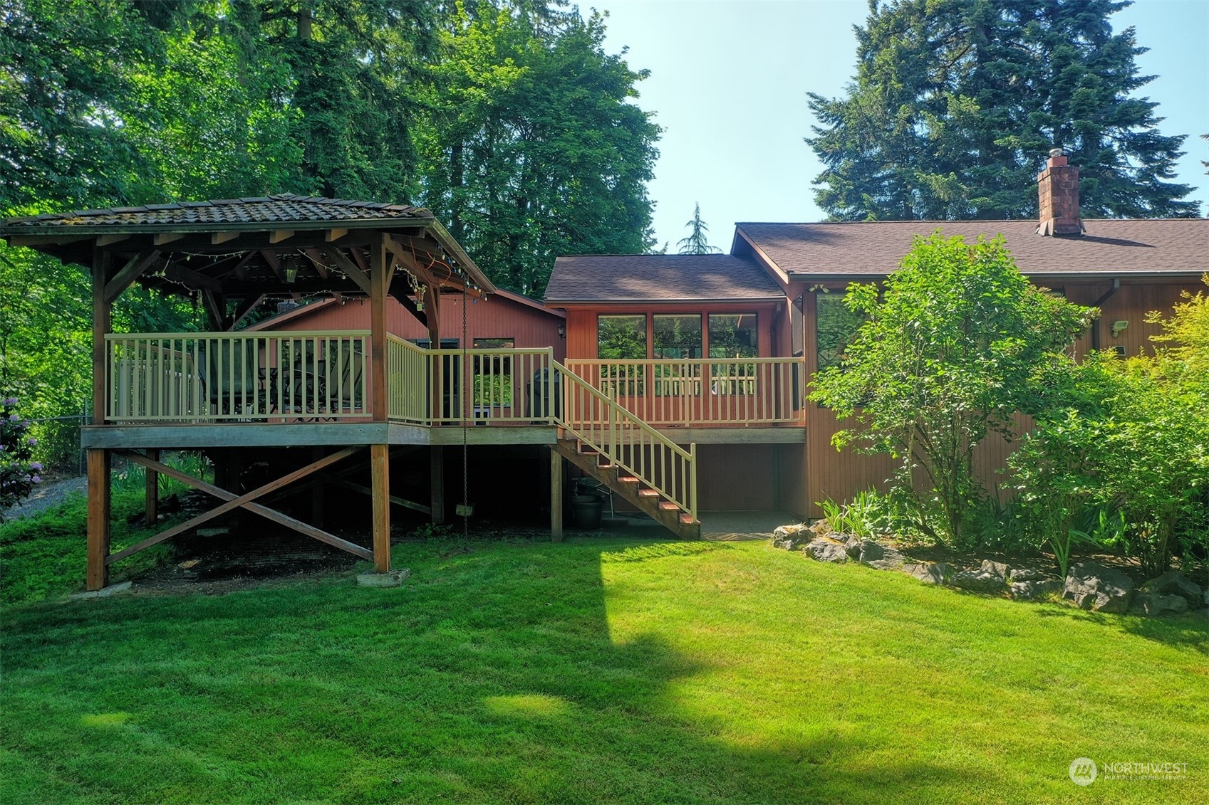 1004 218th Place Southeast Bothell, WA 98021 - Photo 19 of 30 a view of a chair and table in the backyard