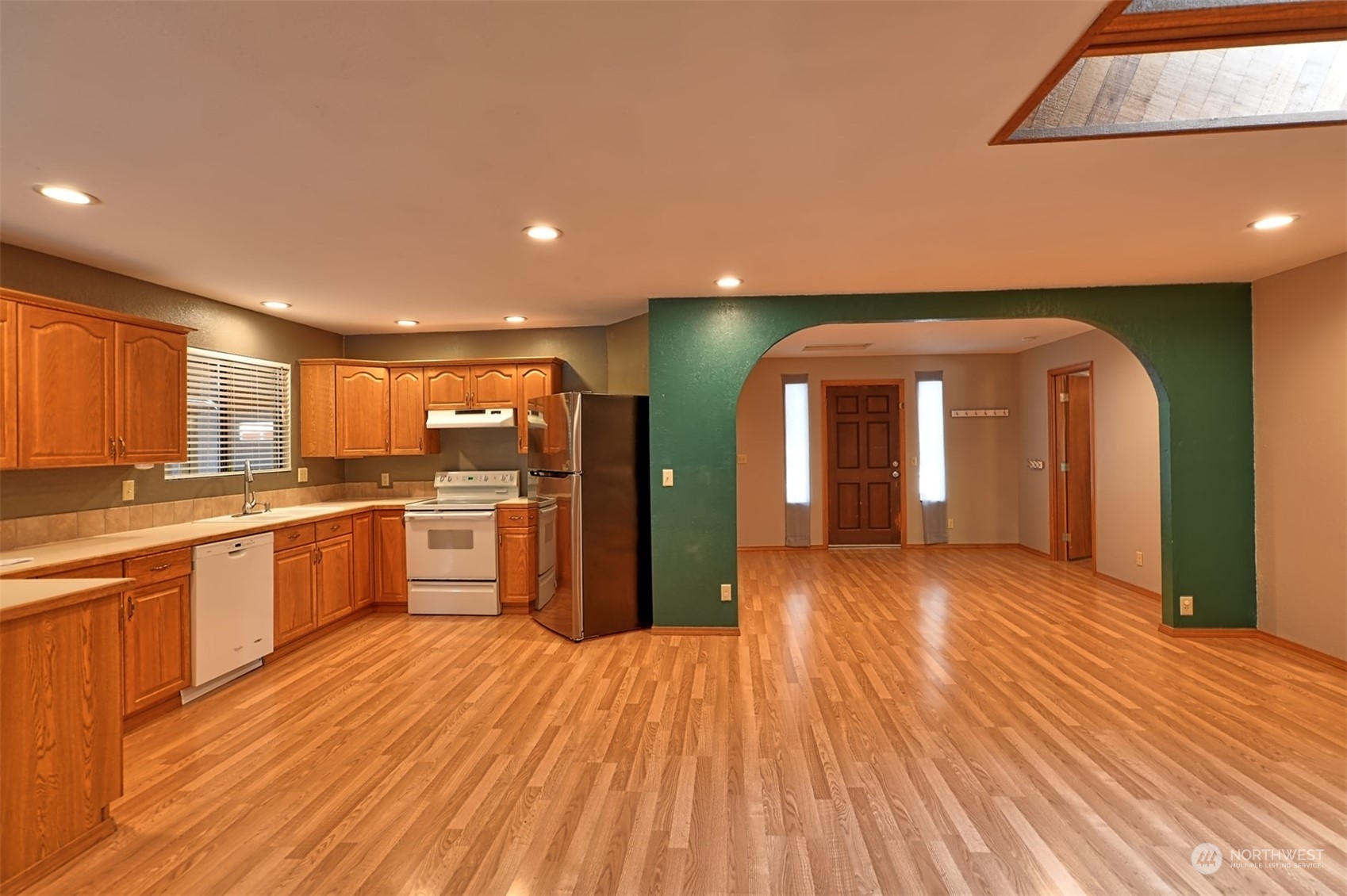 1004 218th Place Southeast Bothell, WA 98021 - Photo 22 of 30 a view of a large kitchen with stainless steel appliances granite countertop a sink and wooden floors