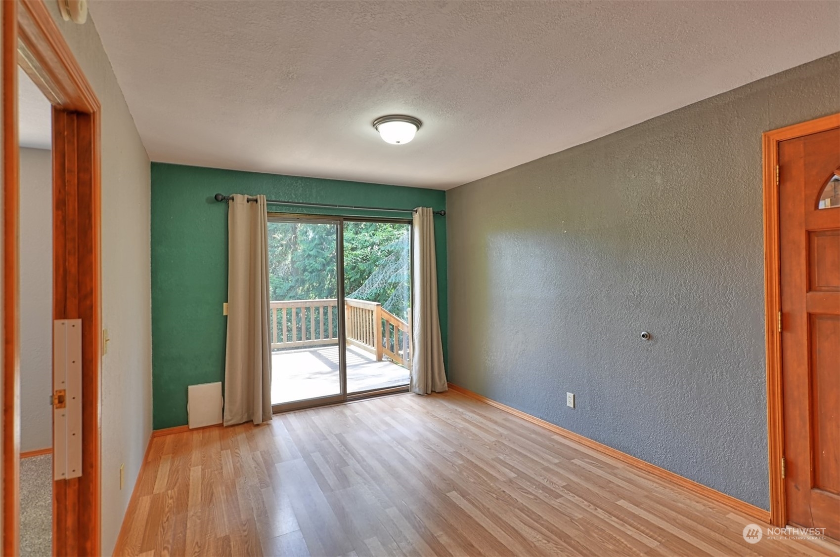 1004 218th Place Southeast Bothell, WA 98021 - Photo 23 of 30 a view of an empty room with wooden floor and a window