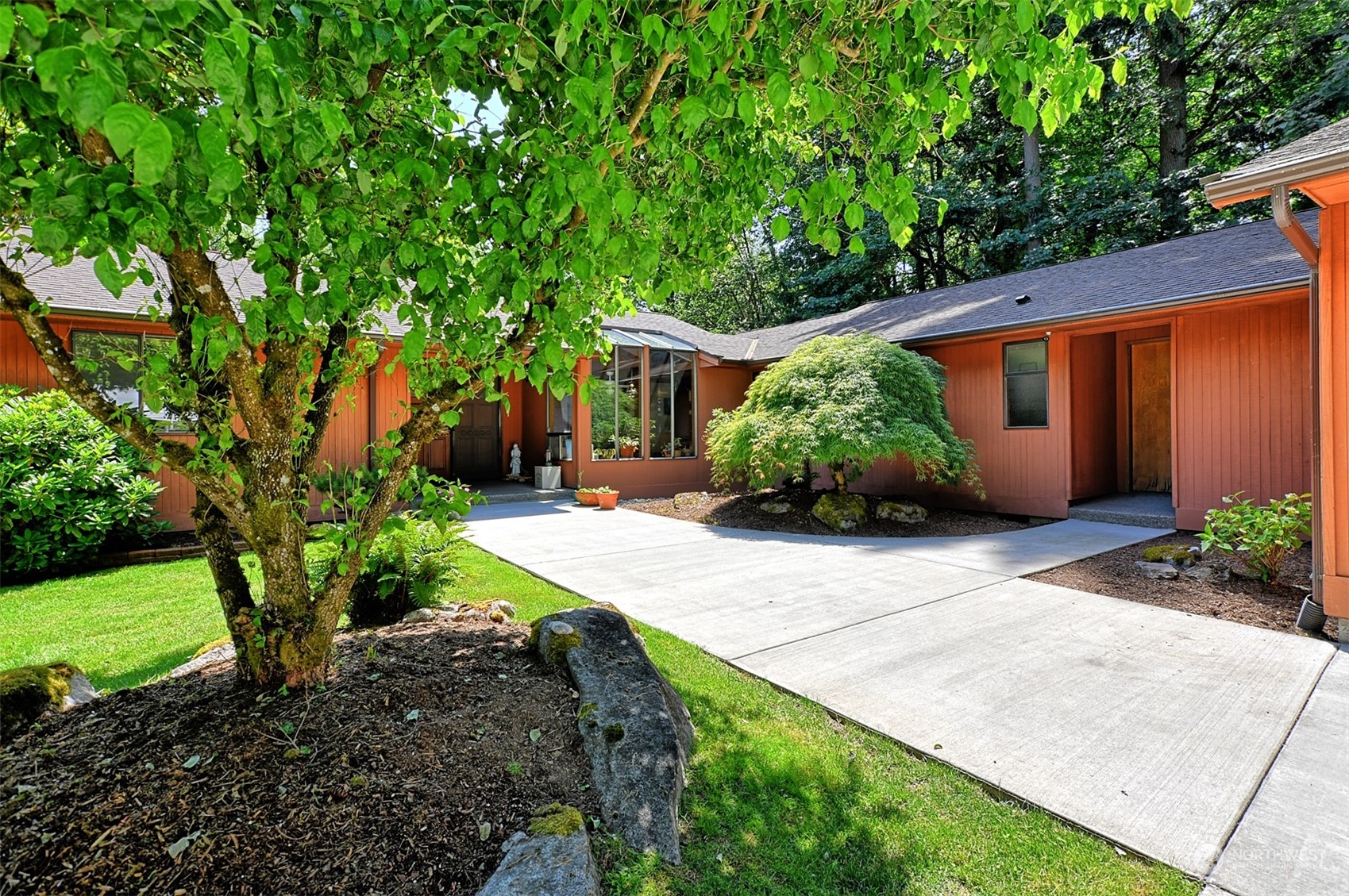 1004 218th Place Southeast Bothell, WA 98021 - Photo 4 of 30 a front view of a house with garden