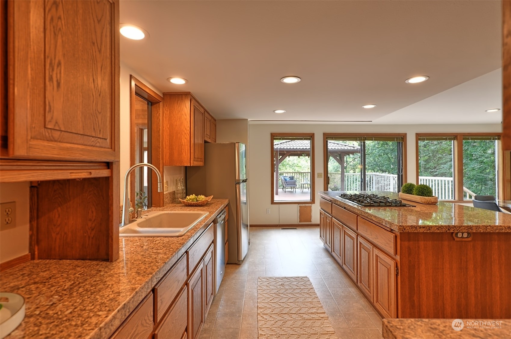 1004 218th Place Southeast Bothell, WA 98021 - Photo 9 of 30 a kitchen with stainless steel appliances granite countertop a stove a sink and a refrigerator
