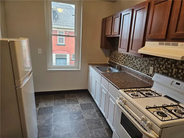 a kitchen with a stove a refrigerator and a stove