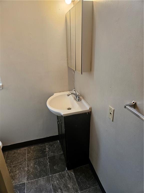 1935 Delaware Avenue, Unit 101 Pittsburgh, PA 15218 - Photo 20 of 20 a bathroom with a sink and a mirror