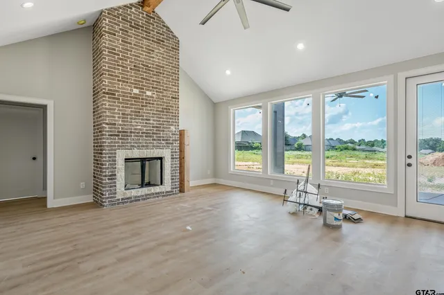 a kitchen with stainless steel appliances granite countertop grey cabinets a stove a sink and dishwasher