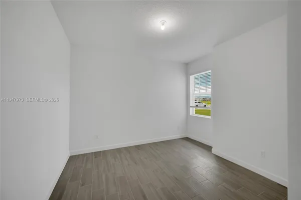 a view of an empty room and a window