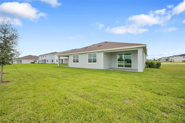 a view of a house with a backyard