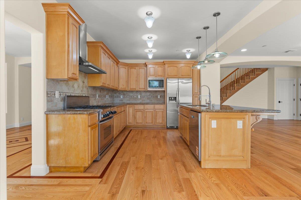 2100 Stone Ridge Drive Watsonville, CA 95076 - Photo 11 of 50 a kitchen with stainless steel appliances granite countertop a stove a sink and a refrigerator
